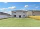 Rear view of home with sliding glass door and large backyard at 362 Rock View Ln, Covington, GA 30016