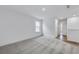 Bright bedroom with plush carpeting, window, and hallway view with wood flooring at 362 Rock View Ln, Covington, GA 30016