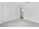 Carpeted bedroom with a double door closet and open door to a hallway at 362 Rock View Ln, Covington, GA 30016