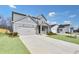 Charming gray home with a spacious driveway, a cozy front porch, and neighborhood view at 362 Rock View Ln, Covington, GA 30016