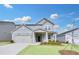 Charming home with a gray exterior, well-manicured lawn, and a two-car garage on a sunny day at 362 Rock View Ln, Covington, GA 30016