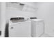 Bright laundry room featuring a Whirlpool washer and dryer and a white wire rack shelf for organized storage at 362 Rock View Ln, Covington, GA 30016
