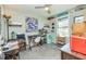 This bright bedroom doubles as an office space with a desk, printer, mini fridge, and lots of natural light at 387 Pine Trail, Canton, GA 30115