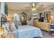 Bright bedroom boasts a ceiling fan, wood furniture, an area rug, and lots of decorative art at 387 Pine Trail, Canton, GA 30115