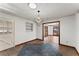 Open-concept dining room featuring stylish modern light fixture and view to living area at 824 Cinderella Way, Decatur, GA 30033