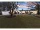 Evening shot of ranch-style home boasting a manicured lawn, mature trees and a brick facade, plus an attached garage at 824 Cinderella Way, Decatur, GA 30033