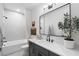 Stylish bathroom featuring a vanity with black hardware, a large mirror, and a tub/shower combination at 315 Chiswick Cir # 38, Alpharetta, GA 30009