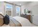 Bright bedroom with hardwood floors, dresser, decorative mirror, and large windows at 315 Chiswick Cir # 38, Alpharetta, GA 30009