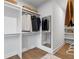 Organized walk-in closet with custom shelving, ample storage, and a full-length mirror, maximizing space at 315 Chiswick Cir # 38, Alpharetta, GA 30009