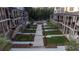 A meticulously landscaped community space sits between townhomes with green space and walkways at 315 Chiswick Cir # 38, Alpharetta, GA 30009