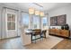 Bright dining room with a modern chandelier, art, a credenza, and a jute rug at 315 Chiswick Cir # 38, Alpharetta, GA 30009