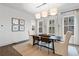 A dining room features neutral decor with picture frame molding, a modern light fixture, and a jute rug at 315 Chiswick Cir # 38, Alpharetta, GA 30009