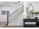 An inviting foyer features an accent table with wood floors and white walls at 315 Chiswick Cir # 38, Alpharetta, GA 30009