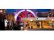 The Avalon: upscale exterior featuring an illuminated sign, an arched entrance, and a bustling atmosphere after dark at 315 Chiswick Cir # 38, Alpharetta, GA 30009
