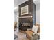 Stylish corner fireplace with dark tile surround, wooden mantel, and glass front at 315 Chiswick Cir # 38, Alpharetta, GA 30009