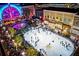 Night aerial shot of an outdoor ice-skating rink, surrounded by lights, stores and festive decorations at 315 Chiswick Cir # 38, Alpharetta, GA 30009