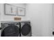 A functional laundry room featuring front-loading washer and dryer with a folding counter above at 315 Chiswick Cir # 38, Alpharetta, GA 30009