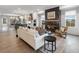 Open-concept living room showcasing a fireplace, hardwood floors, and a seamless transition to the kitchen and dining areas at 315 Chiswick Cir # 38, Alpharetta, GA 30009