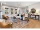 Bright and airy living room featuring hardwood floors, large windows, and stylish furniture for a sophisticated feel at 315 Chiswick Cir # 38, Alpharetta, GA 30009