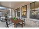 Relaxing covered patio with outdoor seating and brick accents, offering a cozy space for entertaining at 315 Chiswick Cir # 38, Alpharetta, GA 30009