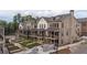 Charming townhomes with brick exteriors and covered porches offer a blend of classic architecture and modern living at 315 Chiswick Cir # 38, Alpharetta, GA 30009