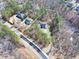 Aerial view showcasing the property's generous lot size, landscaping, and convenient location near a road at 3564 Suwanee Creek Rd, Suwanee, GA 30024