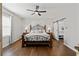 This main bedroom features wood floors, a ceiling fan, and an attached en suite at 3564 Suwanee Creek Rd, Suwanee, GA 30024