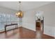 Dining room featuring hardwood flooring, chandelier, and views to the kitchen at 3669 Clearbrooke Way, Duluth, GA 30097