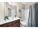 Cozy bathroom featuring a single sink vanity, tub/shower, and neutral decor at 4478 Dunblane Ave, Sugar Hill, GA 30518