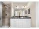 Beautiful bathroom with dual sinks, granite countertops, and glass-enclosed shower at 4478 Dunblane Ave, Sugar Hill, GA 30518