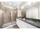Modern bathroom featuring granite countertops, dual sinks, and a glass-enclosed shower at 4478 Dunblane Ave, Sugar Hill, GA 30518