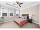 Cozy bedroom with large windows, tray ceiling, and neutral decor at 4478 Dunblane Ave, Sugar Hill, GA 30518