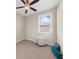 Simple bedroom with neutral walls, soft carpet, and a bright window providing natural light at 4478 Dunblane Ave, Sugar Hill, GA 30518