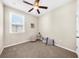 Bedroom with neutral walls, soft carpet, and a bright window with a fan above at 4478 Dunblane Ave, Sugar Hill, GA 30518