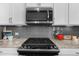 Close up of gas cooktop and stainless steel appliances in the kitchen at 4478 Dunblane Ave, Sugar Hill, GA 30518