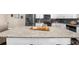 Large kitchen island with stone countertop provides ample space for food preparation and entertaining at 4478 Dunblane Ave, Sugar Hill, GA 30518