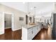 Spacious kitchen with white cabinets, granite counters, and a large center island at 4478 Dunblane Ave, Sugar Hill, GA 30518