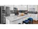 Spacious kitchen with large island, stainless steel appliances, and white cabinetry at 4478 Dunblane Ave, Sugar Hill, GA 30518