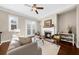 Bright living room features a fireplace, hardwood floors, and elegant French doors at 4478 Dunblane Ave, Sugar Hill, GA 30518