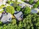 An aerial view shows the home nestled among mature trees in a residential neighborhood at 703 Sierra Ct, Canton, GA 30114