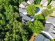 Aerial view of house nestled in neighborhood with mature trees at 703 Sierra Ct, Canton, GA 30114