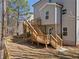Back of house showing wooden deck, stairs, and shaded backyard at 703 Sierra Ct, Canton, GA 30114
