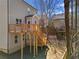 Rear view of the home features an expansive deck and natural wooded surroundings at 703 Sierra Ct, Canton, GA 30114