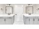 Elegant bathroom featuring double vanities with modern fixtures and lighting at 703 Sierra Ct, Canton, GA 30114
