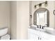 This powder room includes an undermount sink, white vanity, and black faucet at 703 Sierra Ct, Canton, GA 30114