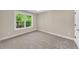 Bright bedroom featuring a large window and neutral carpeting at 703 Sierra Ct, Canton, GA 30114