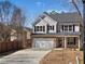 Charming two-story home with a brick facade, attached garage, and long driveway at 703 Sierra Ct, Canton, GA 30114