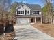 Charming two-story home with a brick facade, attached garage, and long driveway at 703 Sierra Ct, Canton, GA 30114