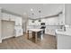 Bright kitchen boasts modern white cabinets, stainless steel appliances, and a central island at 703 Sierra Ct, Canton, GA 30114
