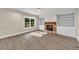 Bright living room features a brick fireplace with built-in shelving, and hardwood floors at 703 Sierra Ct, Canton, GA 30114